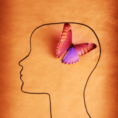 Image of a black outline of a person's head thinking with a purple and pink butterfly